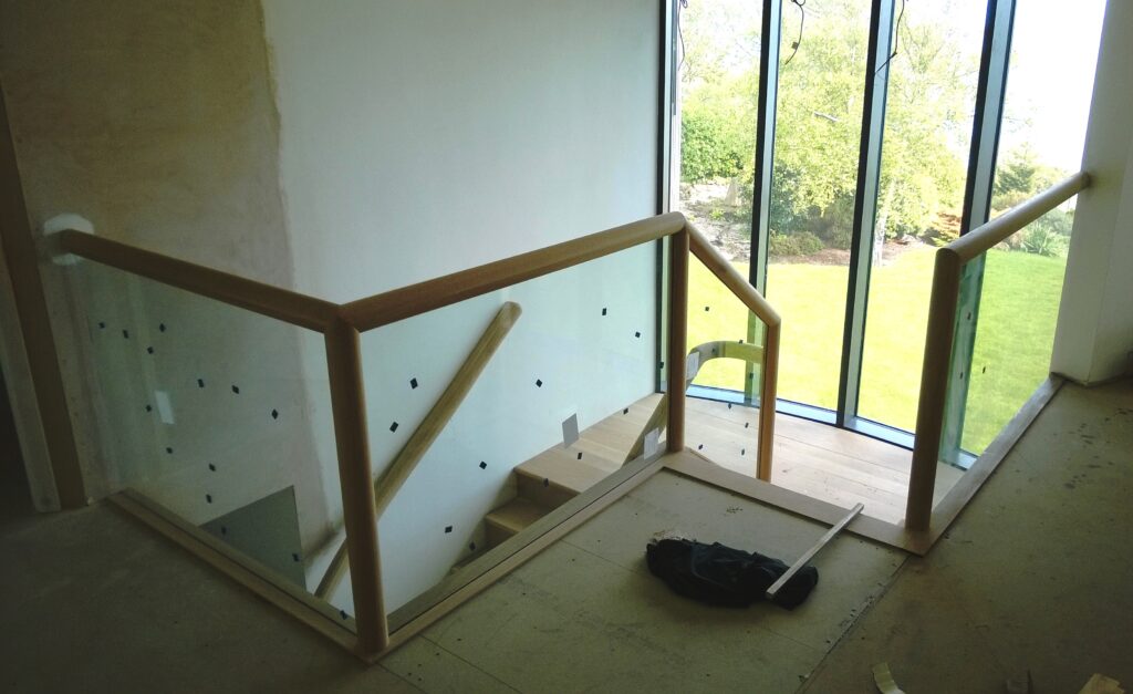 construction glass and wood staircase from landing