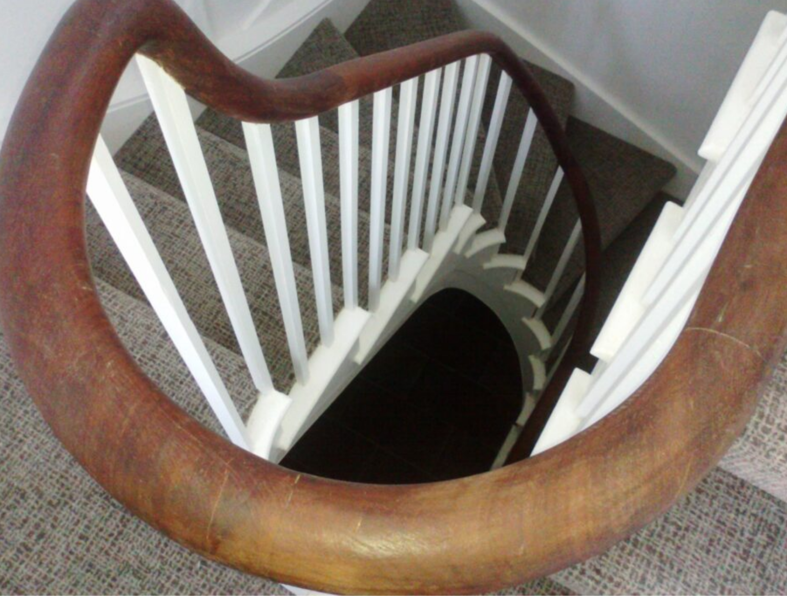 an oak handrail on a spiral staircase in the isle of wight